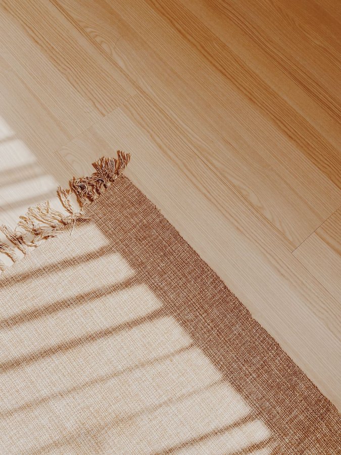 Before and after parquet floor restoration showing dramatic transformation from worn herringbone to gleaming restored wood